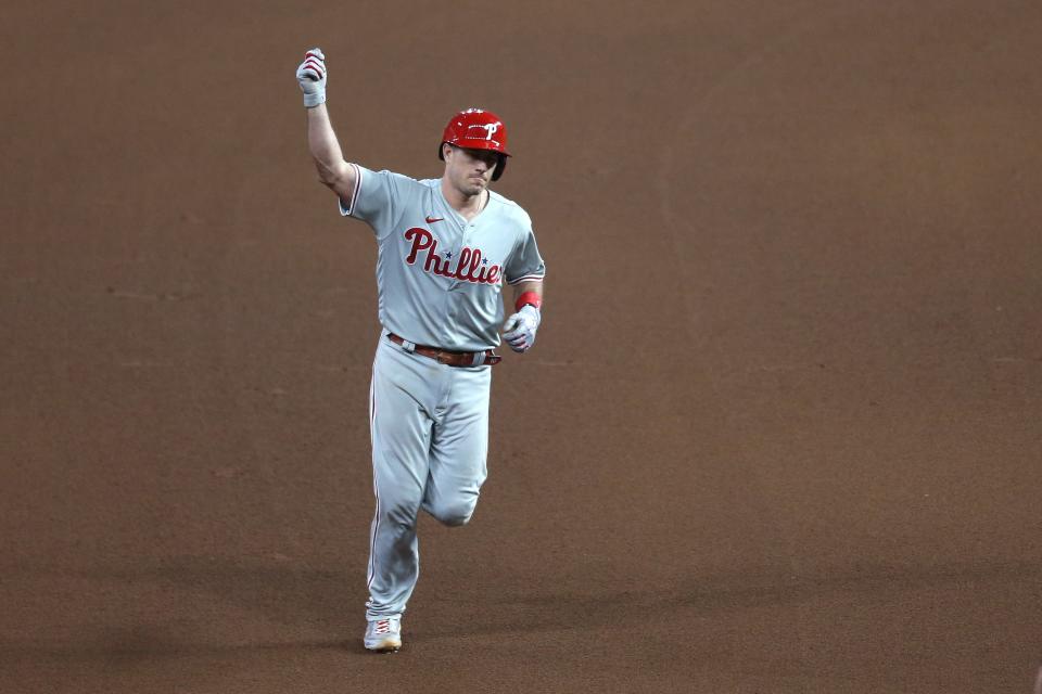 J.T. Realmuto rounds the bases after hitting a solo homer in the 10th inning.