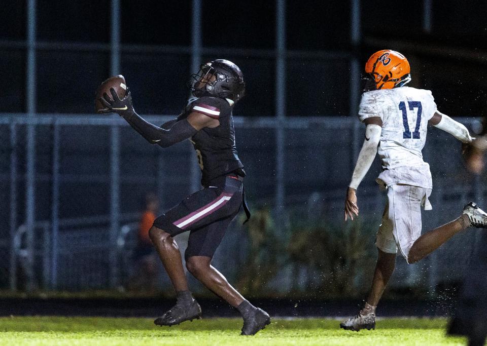 Palm Beach Central wide receiver Kamare Williams makes a touchdown catch against Benjamin cornerback Joshua Smith during their game in Wellington, Florida on October 6, 2023.