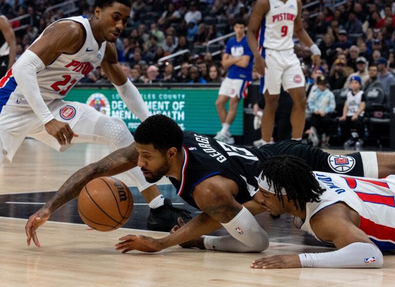 Los Angeles, CA - February 10: Clippers Paul George, no. 13, left, dives for a loose ball.