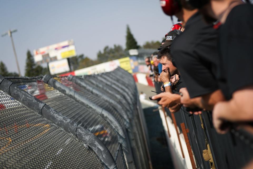 Team members look on during practice laps at the NAPA Auto Parts/ENEOS 150 held at All American Speedway in Roseville, Calif. on Oct. 12, 2019.
