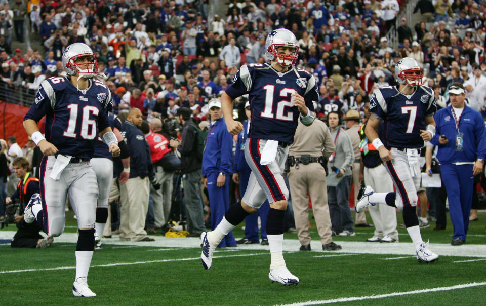 Tom Brady and Matt Cassel run out of the tunnel. (Photo by Harry How/Getty Images)