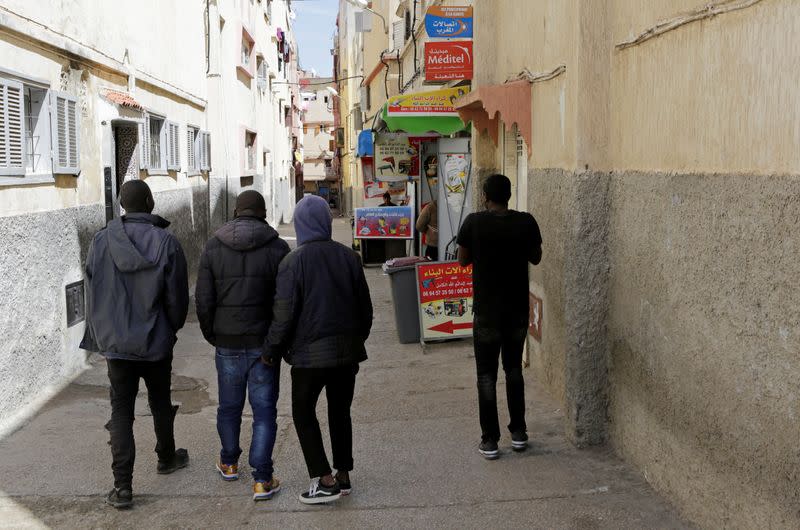 African migrants walk in Hay el Farah area on the outskirts of Rabat