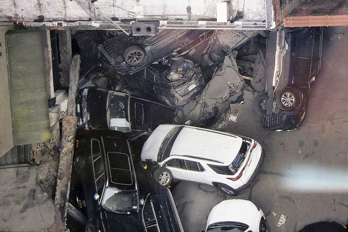 FILE — Cars are seen at the partial collapse of a parking garage in the Financial District of New York, April 19, 2023, in New York. After the deadly collapse of a parking structure in lower Manhattan, New York City building officials swept through dozens of parking garages and ordered four of them to immediately shutter because of structural issues that “deteriorated to the point where they were now posing an immediate threat to public safety.” (Tom Kaminski/WCBS 880 News via AP)
