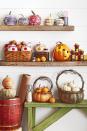 <p>Fill these cutie pumpkin baskets with mini pumpkins or candy for kiddos.<br></p><p>Cut off the top quarter of a flat pumpkin (this is a Musquee de Provence variety); scoop out pulp and seeds. Attach lengths of grapevine just below the opening with T-pins. Attach a grapevine handle just inside the opening with T-pins. Nestle mini pumpkins in the basket. </p>