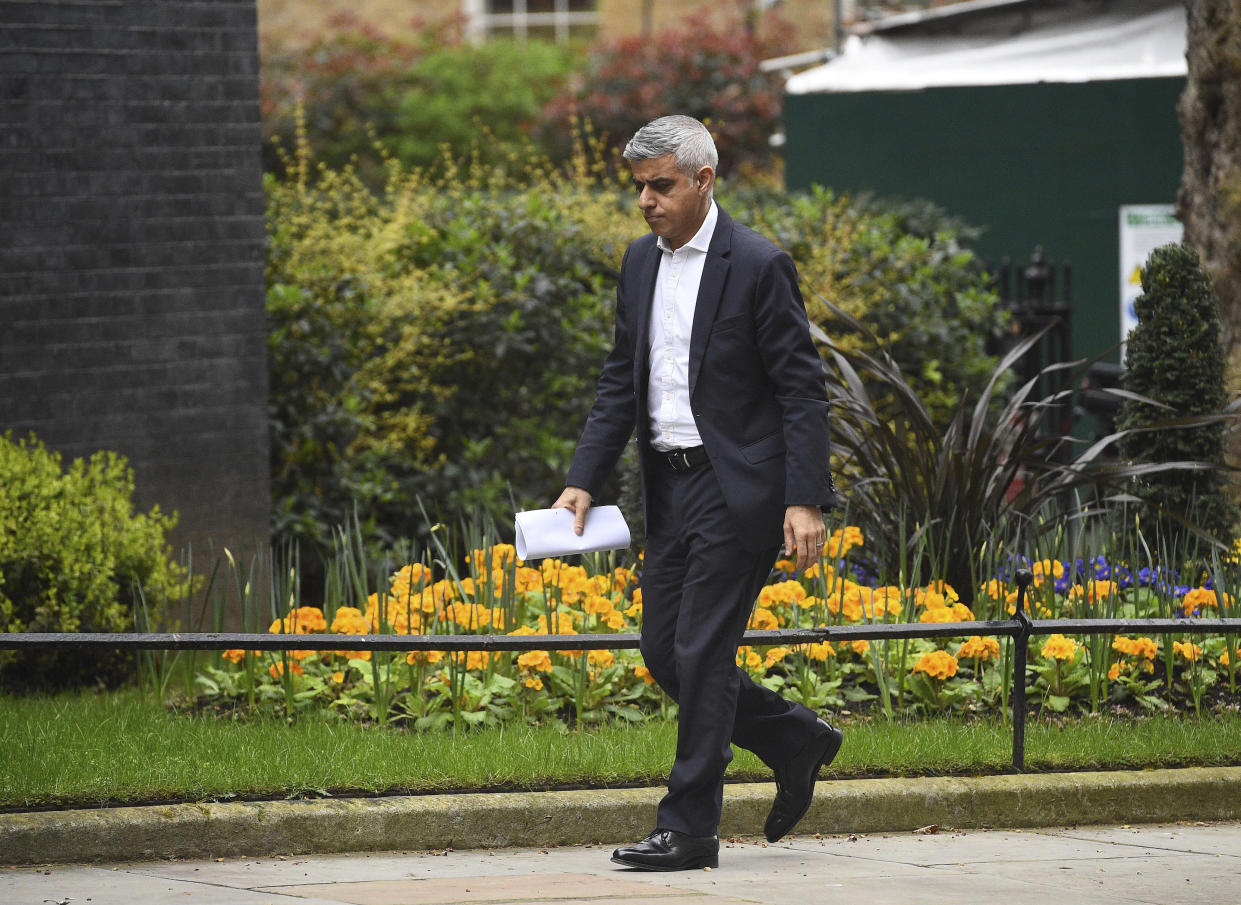 Mayor of London, Sadiq Khan arrives at 10 Downing Street, as the government is expected to publish an emergency coronavirus powers Bill, in London, Thursday March 19, 2020.  For some people the new COVID-19 coronavirus causes only mild or moderate symptoms, but for some it can cause severe illness. (Kirsty O'Connor / PA via AP)