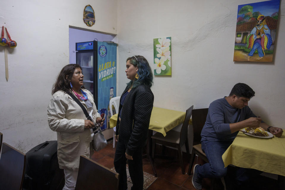 Nicaraguan Xaviera Molina, center, who was granted asylum in Costa Rica, listens to Ruth Blass Lopez who is applying for asylum, at a diner that serves traditional Nicaraguan food ownd by a Nicaraguan asylum-seeker in San Jose, Costa Rica, Friday, Aug. 26, 2022. Molina, a marketing major, was a single mother at the time in the second year of her degree track when students expanded the protest against Ortega’s government and she got involved, first distributing food and then eventually helping provide medical care to wounded students. (AP Photo/Moises Castillo)