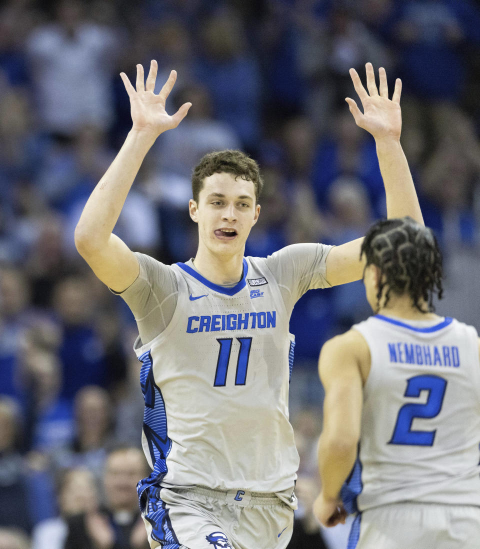 Creighton's Ryan Kalkbrenner (11) celebrates with Ryan Nembhard (2) after dunking against UConn during the second half of an NCAA college basketball game on Saturday, Feb. 11, 2023, in Omaha, Neb. Creighton defeated UConn 56-53. (AP Photo/Rebecca S. Gratz)