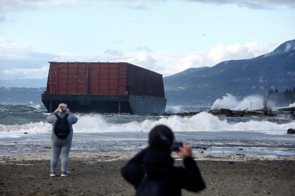 <p>People take photos of a barge that came loose from its mooring and crashed against the sea wall after rainstorms lashed the western Canadian province of British Columbia in Vancouver, British Columbia, Canada November 15, 2021. REUTERS/Jesse Winter</p> 