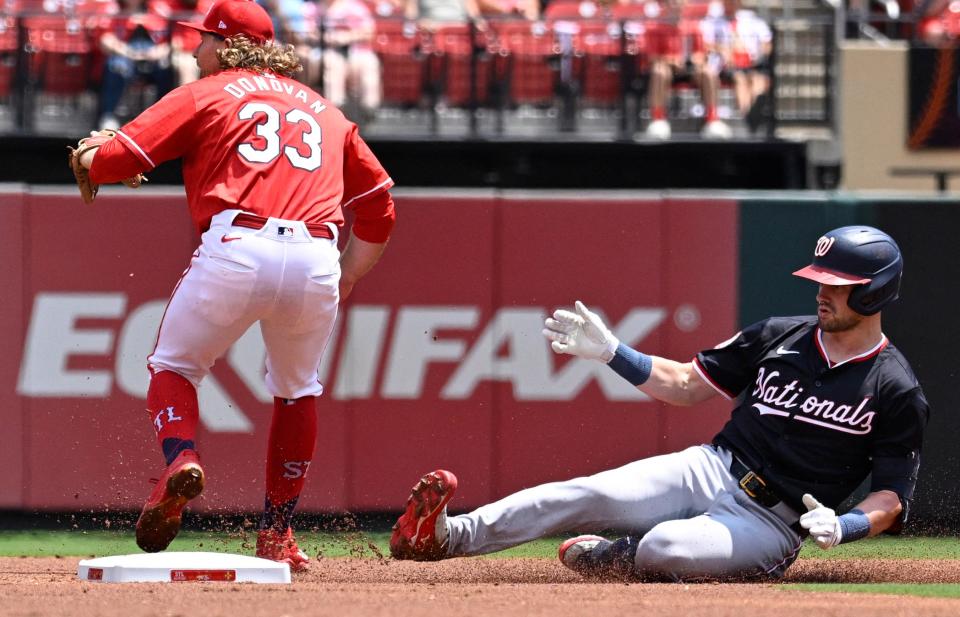 Nationals right fielder Lane Thomas slides into second after hitting a first-inning double against the Cardinals, July 28, 2024, in St. Louis.