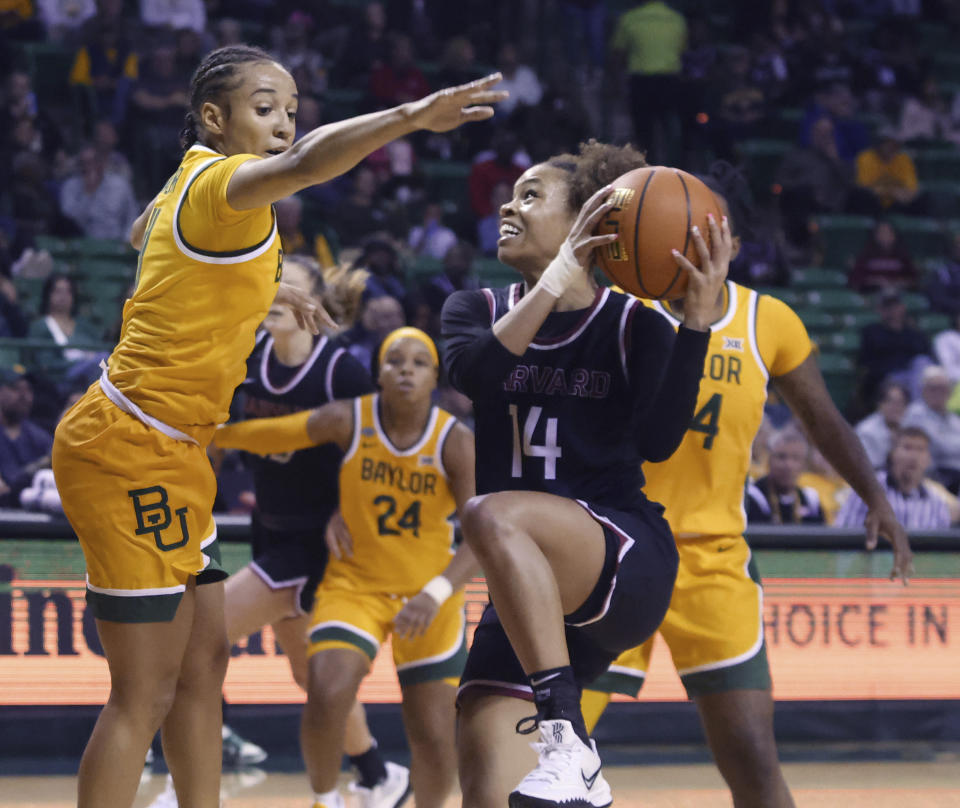 Harvard guard Harmoni Turner, right, attempts a shot over Baylor guard Jada Walker, left, in the first half of an NCAA college basketball game, Sunday, Nov. 19, 2023, in Waco, Texas. (Rod Aydelotte/Waco Tribune-Herald via AP)