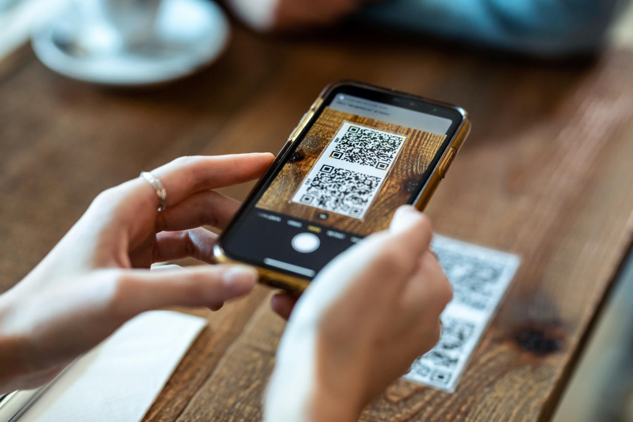 Person scanning QR code on table