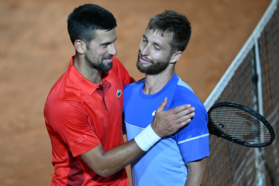 France's Corentin Moutet is comforted by Serbia's Novak Djokovic after being defeated during the Men's ATP Rome Open tennis tournament at Foro Italico in Rome on May 10, 2024. (Photo by Filippo MONTEFORTE / AFP) (Photo by FILIPPO MONTEFORTE/AFP via Getty Images)