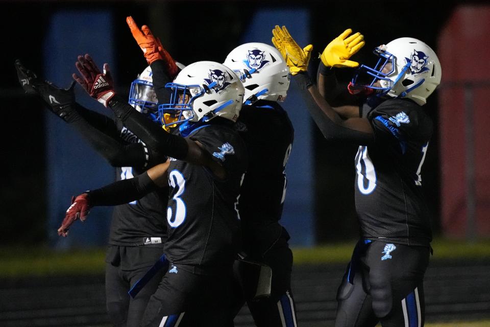 Pahokee High players celebrate a touchdown against Glades Central during the first half of a high school football game at Pahokee High School in Pahokee, Florida, Nov. 3, 2023.