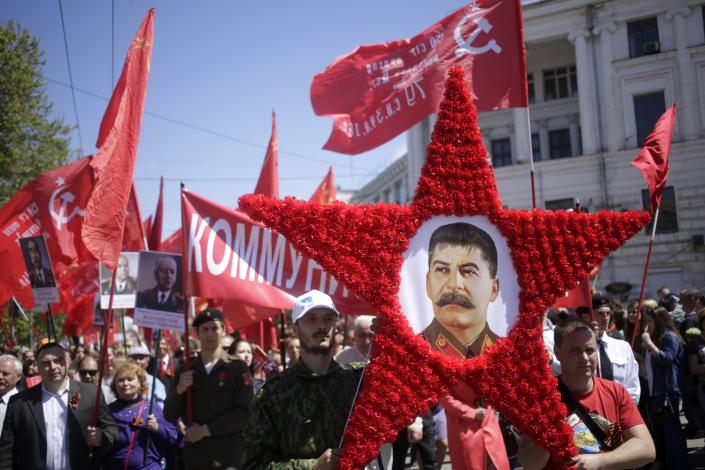 People carry a portrait of Soviet leader Joseph Stalin as they mark 70th anniversary of the end of World War II on May 9, 2015. (Max Vetrov/AFP via Getty Images)