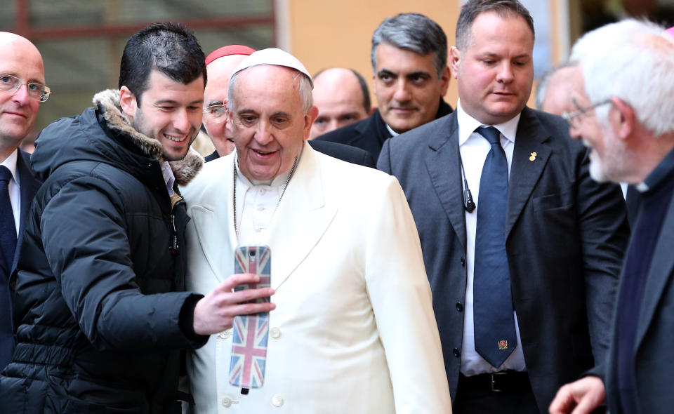 ROME, ITALY - FEBRUARY 08:  Pope Francis poses for a selfie with a the faithful as he pays a visit to the Roman parish of St. Michael the Archangel in Pietralata on February 8, 2015 in Rome, Italy. Following the Angleus prayer on Sunday, Pope Francis spoke about first International Day of Prayer and Awareness against Human Trafficking. The Day of Prayer occurs on 8 February, the liturgical memorial of St. Josephine Bakhita, a Sudanese sister who, as a child, was herself a victim of slavery and human trafficking.  (Photo by Franco Origlia/Getty Images)