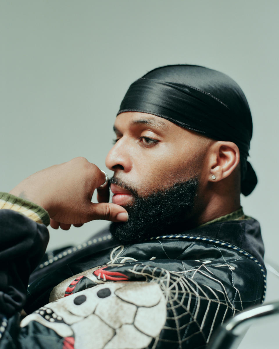 Daniel Daley of dvsn wearing black printed leather jacket with durag