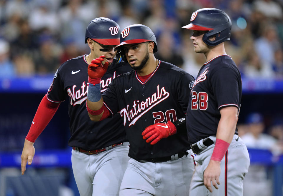 Washington Nationals' Keibert Ruiz, center, celebrates his three-run home run against the Toronto Blue Jays with Joey Meneses, left, and Lane Thomas during the fifth inning of a baseball game Tuesday, Aug. 29, 2023, in Toronto. (Frank Gunn/The Canadian Press via AP)