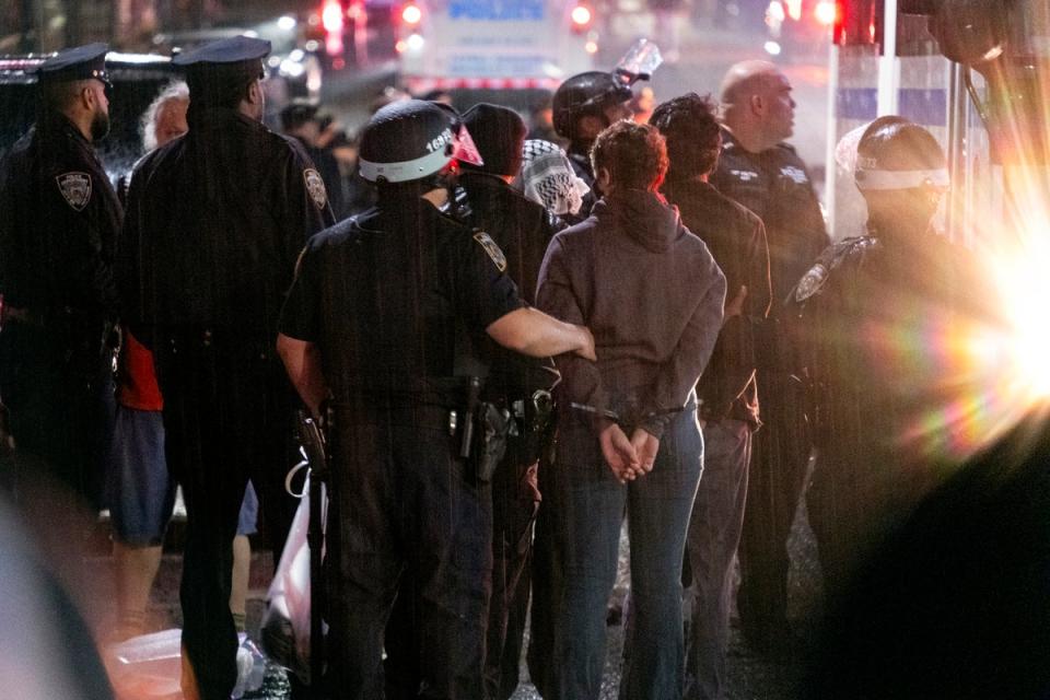 New York City police officers take people into custody near the Columbia University campus in New York on 30 April (Copyright The Associated Press 2024)