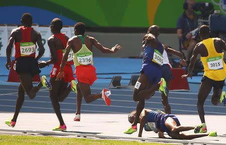 2016 Rio Olympics - Athletics - Preliminary - Men's 5000m Round 1 - Olympic Stadium - Rio de Janeiro, Brazil - 17/08/2016. Hassan Mead (USA) of USA falls over after colliding with Mo Farah (GBR) of Britain. REUTERS/David Gray