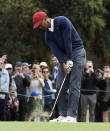 USA captain Tiger Woods hits an approach shot during a practice session ahead of the President's Cup Golf tournament in Melbourne, Tuesday, Dec. 10, 2019. (AP Photo/Andy Brownbill)