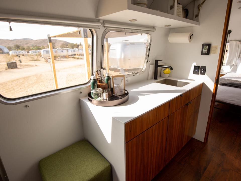 Autocamp Joshua Tree's Airsteram trailer with a kitchen near the bedroom and windows.