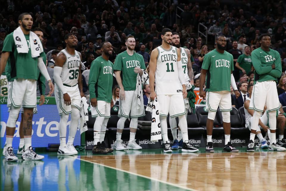 The Boston Celtics watch from the bench during the second half of a preseason NBA basketball game against the Charlotte Hornets in Boston, Sunday, Oct. 6, 2019. (AP Photo/Michael Dwyer)