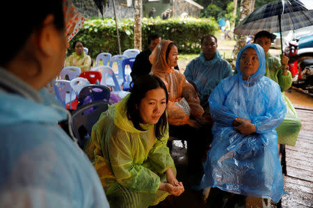 Family members pass their time as they wait for their children near Tham Luang caves during a search for 12 members of an under-16 soccer team and their coach, in the northern province of Chiang Rai, Thailand, June 27, 2018. REUTERS/Soe Zeya Tun