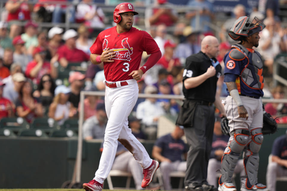 St. Louis Cardinals' Dylan Carlson (3) scores past Houston Astros catcher Martin Maldonado on single hit by Willson Contreras during the second inning of a spring training baseball game, Monday, March 6, 2023, in Jupiter, Fla. (AP Photo/Lynne Sladky)