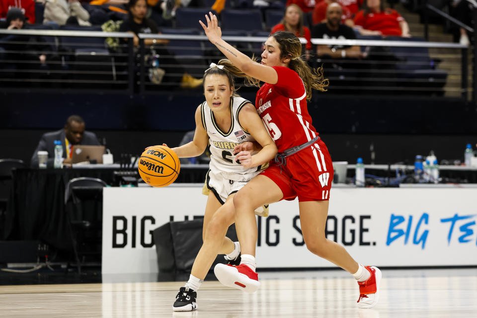 MINNEAPOLIS, MN – MARCH 02: Abbey Ellis #23 of the <a class="link " href="https://sports.yahoo.com/ncaaw/teams/purdue/" data-i13n="sec:content-canvas;subsec:anchor_text;elm:context_link" data-ylk="slk:Purdue Boilermakers;sec:content-canvas;subsec:anchor_text;elm:context_link;itc:0">Purdue Boilermakers</a> is fouled by Sania Copeland #15 of the <a class="link " href="https://sports.yahoo.com/ncaaw/teams/wisconsin/" data-i13n="sec:content-canvas;subsec:anchor_text;elm:context_link" data-ylk="slk:Wisconsin Badgers;sec:content-canvas;subsec:anchor_text;elm:context_link;itc:0">Wisconsin Badgers</a> in the first half of the game in the second round of the Big Ten Women’s Basketball Tournament at Target Center on March 2, 2023 in Minneapolis, Minnesota. (Photo by David Berding/Getty Images)