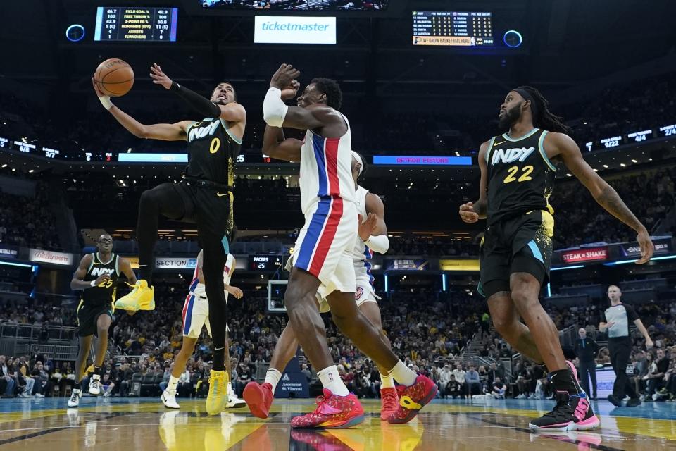 Indiana Pacers' Tyrese Haliburton (0) looks to shoot against Detroit Pistons' Stanley Umude, center front, during the first half of an NBA basketball In-Season Tournament game Friday, Nov. 24, 2023, in Indianapolis. (AP Photo/Darron Cummings)