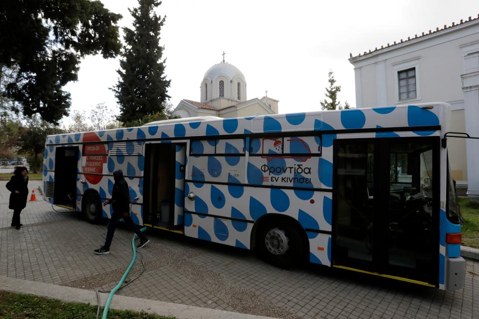 A homeless person leaves a shower bus run by a non-governmental organization in central Athens. Poverty rates have surged in Greece since the start of an economic crisis in late 2009.