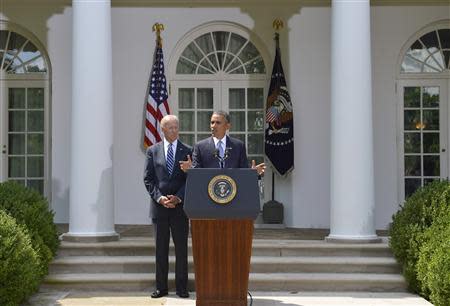 U.S. President Barack Obama speaks next to Vice President Joe Biden (L) at the Rose Garden of the White House August 31, 2013, in Washington. REUTERS/Mike Theiler