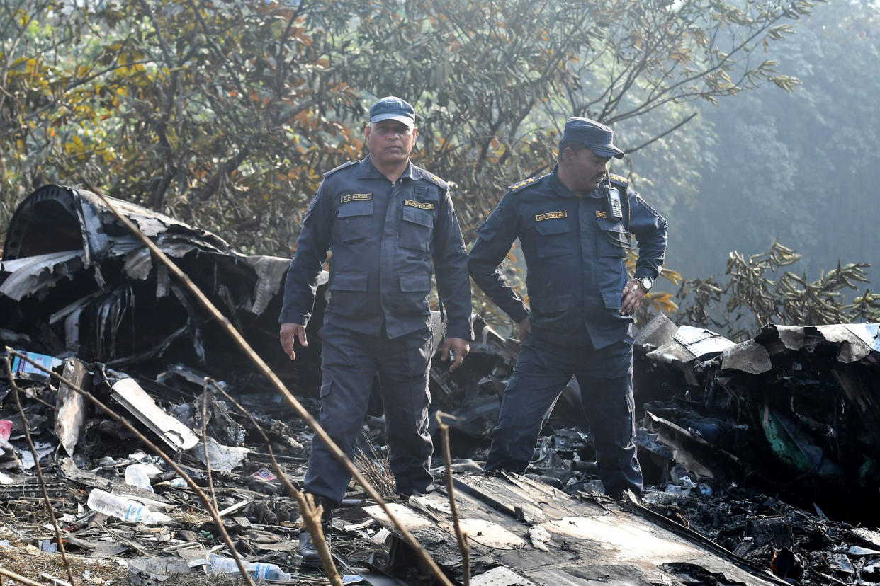 Rescuers inspect the wreckage of a plane crash in Pokhara, Nepal, on Jan. 15, 2023. (Prakash Mathema / AFP - Getty Images)