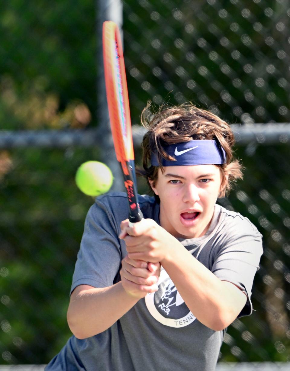 Cape Cod Academy number two singles player Ben Catalano backhands a shot at his Sturgis opponent.