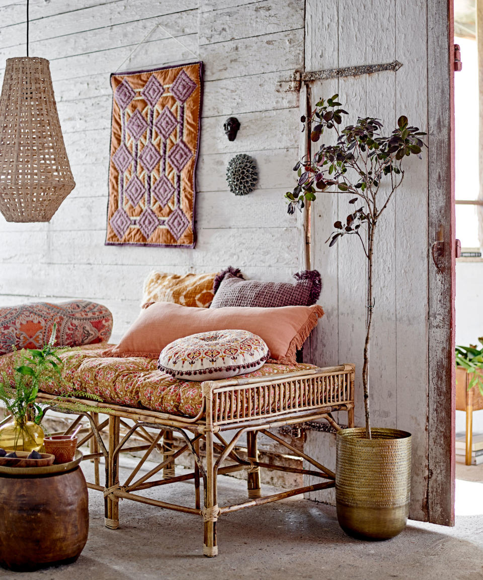 1. Layer bold patterns over warm neutrals in a boho living room