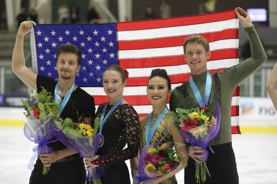 First-place finishers Madison Chock and Evan Bates, right, celebrates with Christina Carreira and Anthony Ponomarenko, left, both of the United States, following the free dance competition at the U.S. International Figure Skating Classic on Saturday, Sept. 21, 2019, in Salt Lake City. (AP Photo/Rick Bowmer)