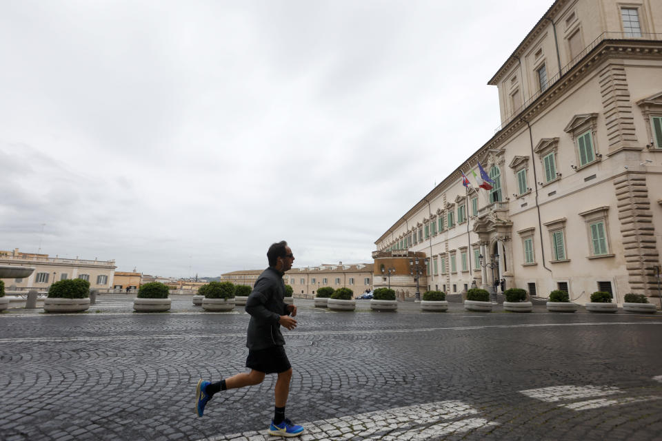 A man jogs in front of the Quirinale presidential palace in Rome where Ukrainian president Volodymr Zelenskyy is expected to meet with Italian President Sergio Mattarella, Saturday, May 13, 2023. Zelenskyy is in Italy for a one-day visit and will meet with Pope Francis at The Vatican. (AP Photo/Riccardo de Luca)