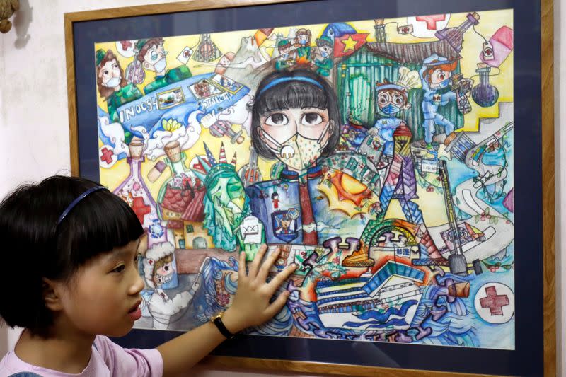 A Vietnamese school girl draws paintings about the coronavirus disease (COVID-19) in Hanoi