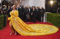 When Rihanna first stepped onto the red carpet in 2015, all jaws hit the ground as she stunned in a design by Guo Pei, a legendary Chinese designer who was featured prominently in the exhibit itself. Later, though, the photos of her cape spiraled into <a href="https://www.teenvogue.com/story/rihanna-met-gala-2017-gown-twitter-reaction?mbid=synd_yahoo_rss" rel="nofollow noopener" target="_blank" data-ylk="slk:countless memes;elm:context_link;itc:0;sec:content-canvas" class="link ">countless memes</a>, ranging from an omelet to a pizza pie, the yellow brick road, and more. (It's still <em>the</em> iconic Met Gala 'fit regardless!)
