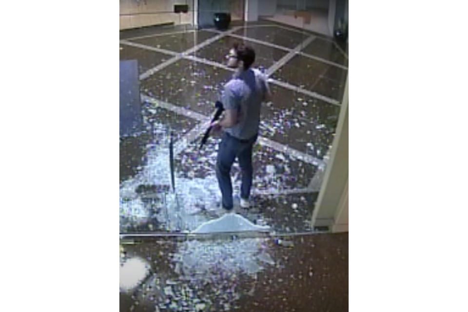 FILE - This image taken from surveillance video provided by the Louisville Metro Police Department shows bank employee Connor Sturgeon, 25, carrying an AR-15 assault-style rifle after opening fire at Old National Bank, in Louisville, Ky., Monday, April 10, 2023. Sturgeon, a man who opened fire at a Louisville bank, killing five co-workers, had confronted mental health problems over the last year and the situation appeared to be managed until just days before the shooting, his mother said. (Courtesy of Louisville Metro Police Department via AP, File)