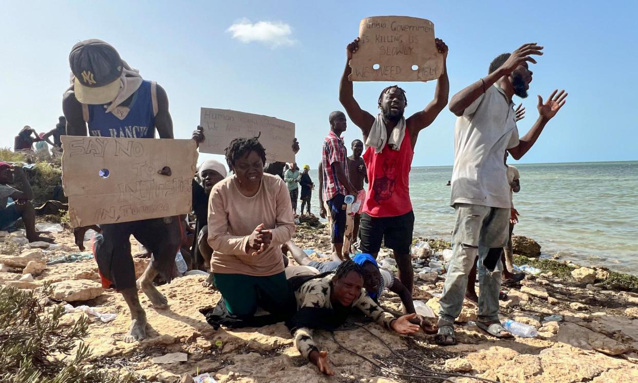 <span>Migrants beg for help in Ras Jedir on the Libya-Tunisia border after being expelled from Sfax last year. Desperate stories have emerged of the fate of those travelling to the Tunisian city.</span><span>Photograph: EPA</span>