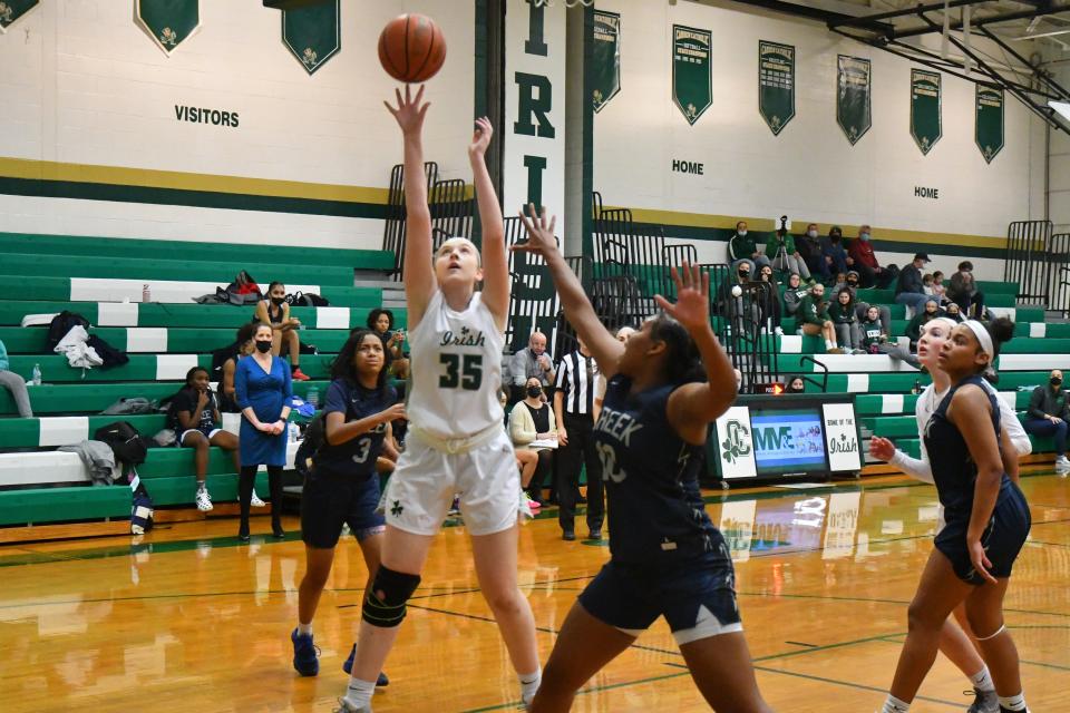 Camden Catholic senior Srah Johnson rises up for a layup against Timber Creek forward Taja Brown