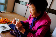 Lee Yong-soo, 90, one of less than 30 known surviving South Korean victims of JapanÕs wartime brothels, displays a photograph in Daegu, South Korea October 30, 2018, of her taken shortly after she returned to Korea in 1945 after being held at an airbase for kamikaze pilots in Taiwan. Picture taken October 30, 2018. REUTERS/ Josh Smith