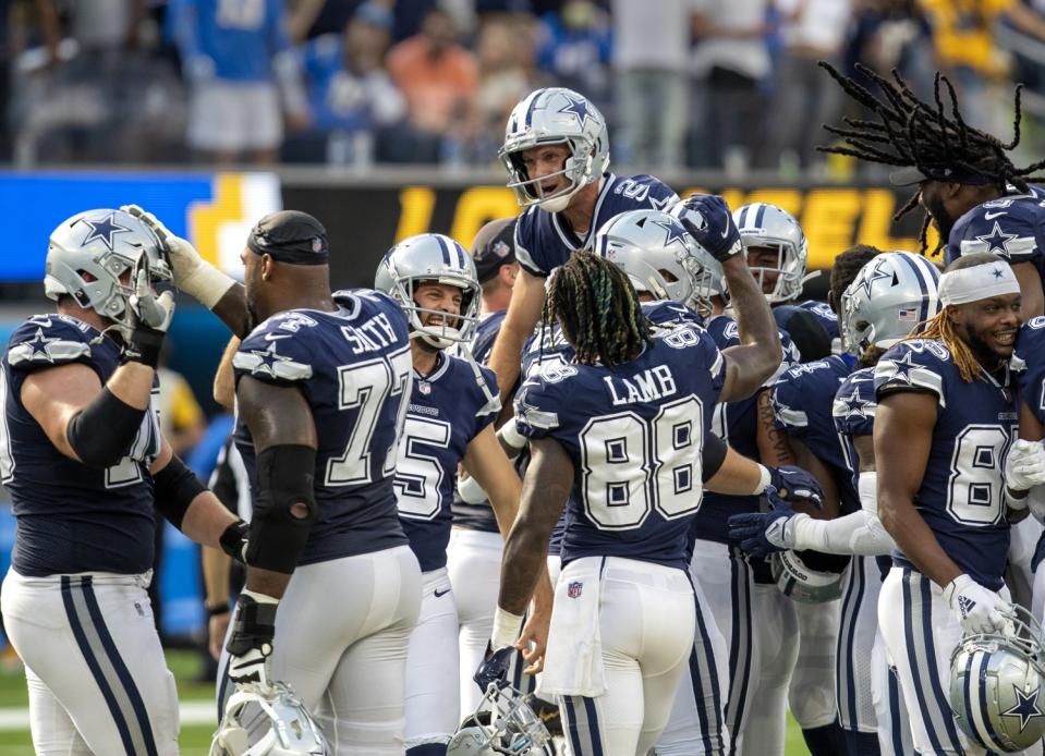 The Cowboys celebrate and hoist Greg Zuerlein after the kicker's 56-yard field goal won the game.