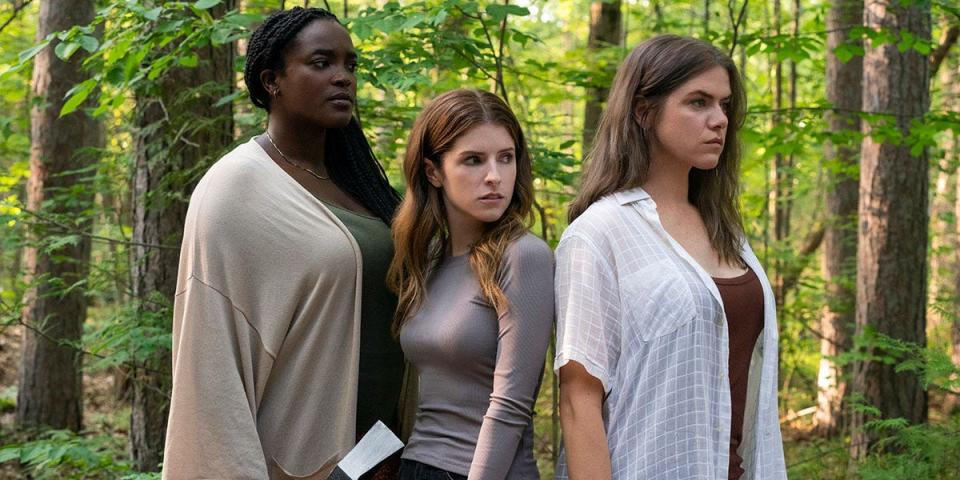 Anna Kendrick holding an axe in between two women