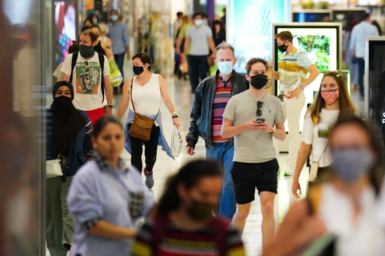 Shoppers in masks (PA Wire)