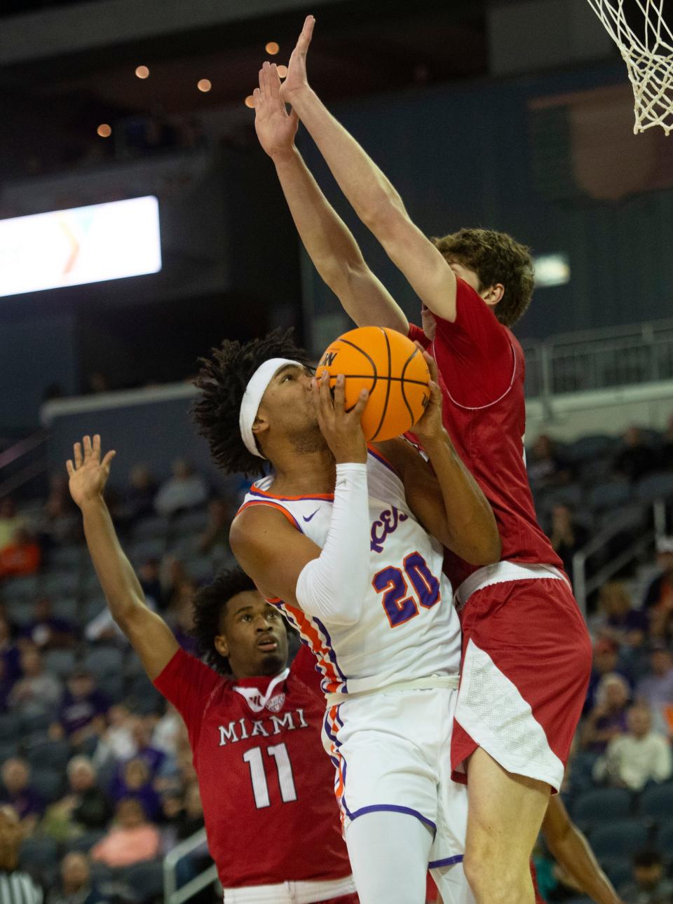 Evansville’s Kenny Strawbridge Jr. (20) goes up against Maimi Ohio’s Reece Potter (35) as the University of Evansville Purple Aces play the Miami (Ohio) University Redhawks at Ford Center in Evansville, Ind., Monday, Nov. 6, 2023.