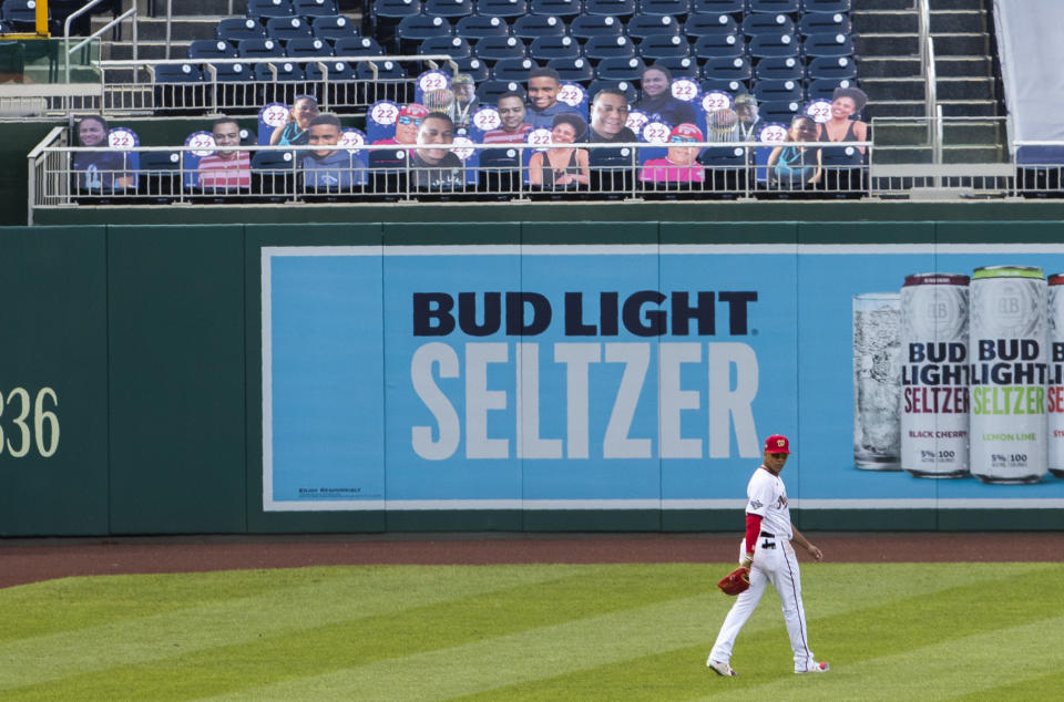 Washington Nationals left fielder Juan Soto walks near cut outs with number 22 on the bleacher during the first inning of a baseball game against the New York Mets in Washington, Wednesday, Aug. 5, 2020. (AP Photo/Manuel Balce Ceneta)