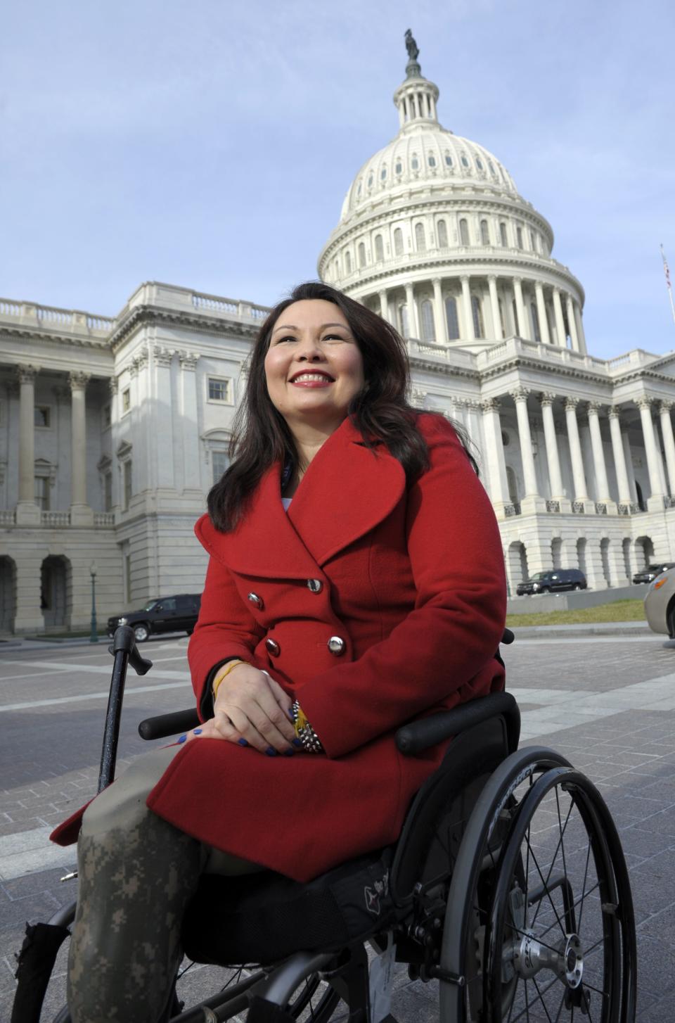 Rep. Tammy Duckworth, D-Ill. is seen on Capitol Hill in Washington, Thursday, Jan. 3, 2013, as she poses with other female House members prior to the official opening of the 113th Congress.