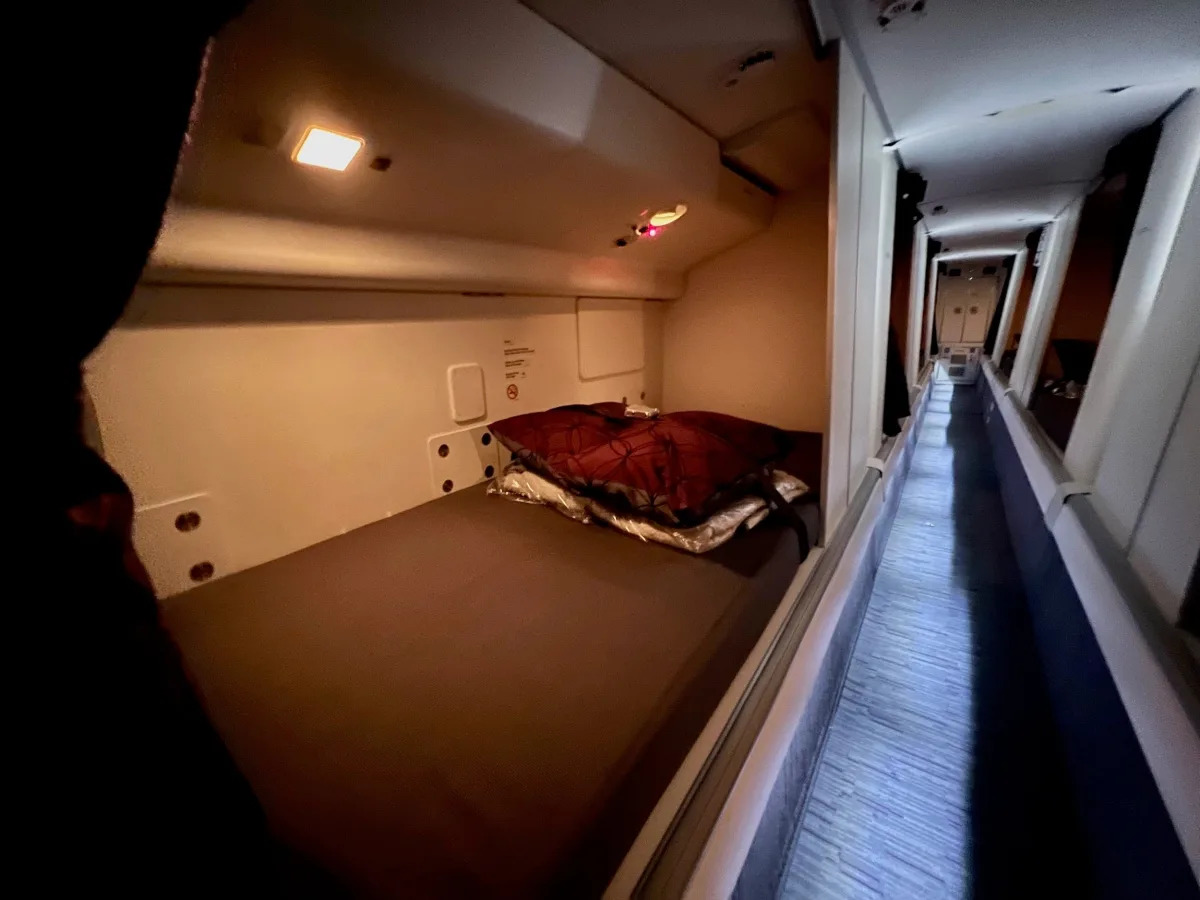 I went inside the secret room where flight attendants sleep on Qatar's Boeing 77..